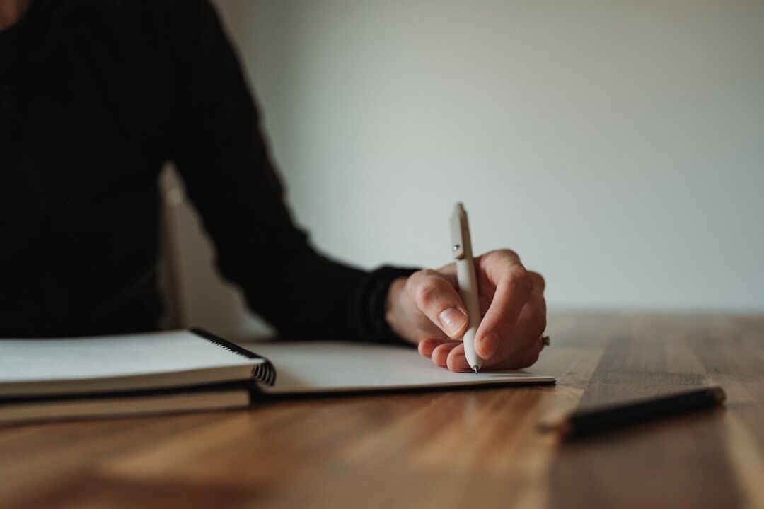 person writing in notebook